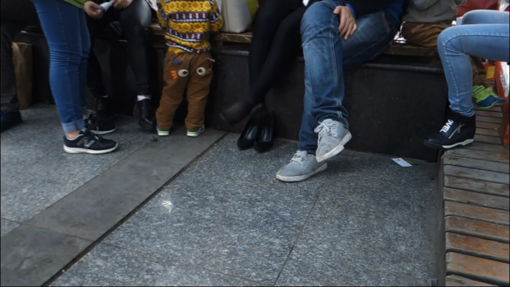 She Sit Down with Family to Rest a Walk while Looking and Play Shoe